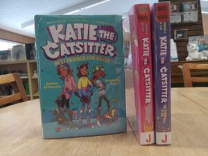Book cover for the 2nd Katie the Catsitter Graphic Novel, and the spines of books 3 and 4