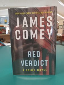 Cover for 'Red Verdict: A Crime Novel', featuring a red and black photo of the exterior of a courthouse
