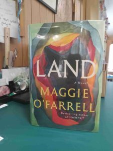 Cover for the novel 'Land', an abstract collage of paper