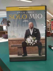 DVD case for the movie 'Solo Mio', featuring a man in a suit on a bunch, holding a bouquet of white flowers