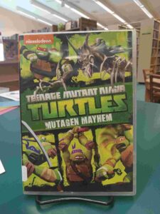 Photo of the cover for the DVD case for 'Teenage Mutant Ninja Turtles: Mutagen Mayhem', featuring all 4 turtles and a mutated wolf creature