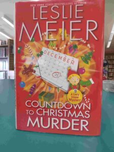 Photo of the cover for the mystery novel 'Countdown to Christmas Murder', featuring a calendar for the month of December surrounded by Christmas decorations