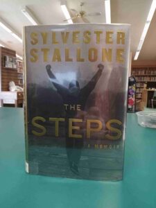 Photo of the cover for the memoir 'The Steps, featuring a photo from the steps scene in the movie Rocky