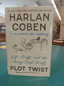 Cover of the book, with a beige background and a sketched image of a man at a desk with two dogs next to him.